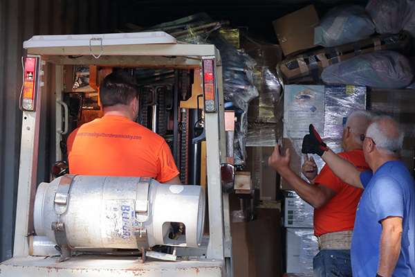 Volunteers load pallets filled with medical aid, food, clothing and hygiene kits on Sept. 8, 2023. It was the 38th container that Crossing All Borders of Angier, North Carolina, has sent to Ukraine since the war began.