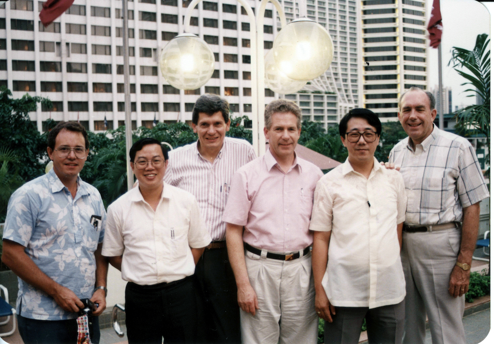 Reeder and five other TWR leaders lined up in a row facing the camera in Singapore.