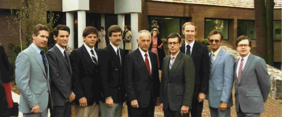 John Reeder, former representative for TWR in Australia, and several key TWR leaders standing in front of the old TWR US office building in Chatham, New Jersey, in 1984.