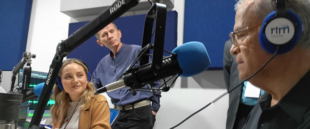 Kimberly Yepes interviews longtime TWR missionary Jim Munger as audio producer-director Lionel Herrera looks on.