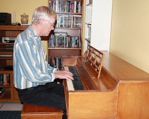 David Rittenhouse plays the piano at their home in 2013. 