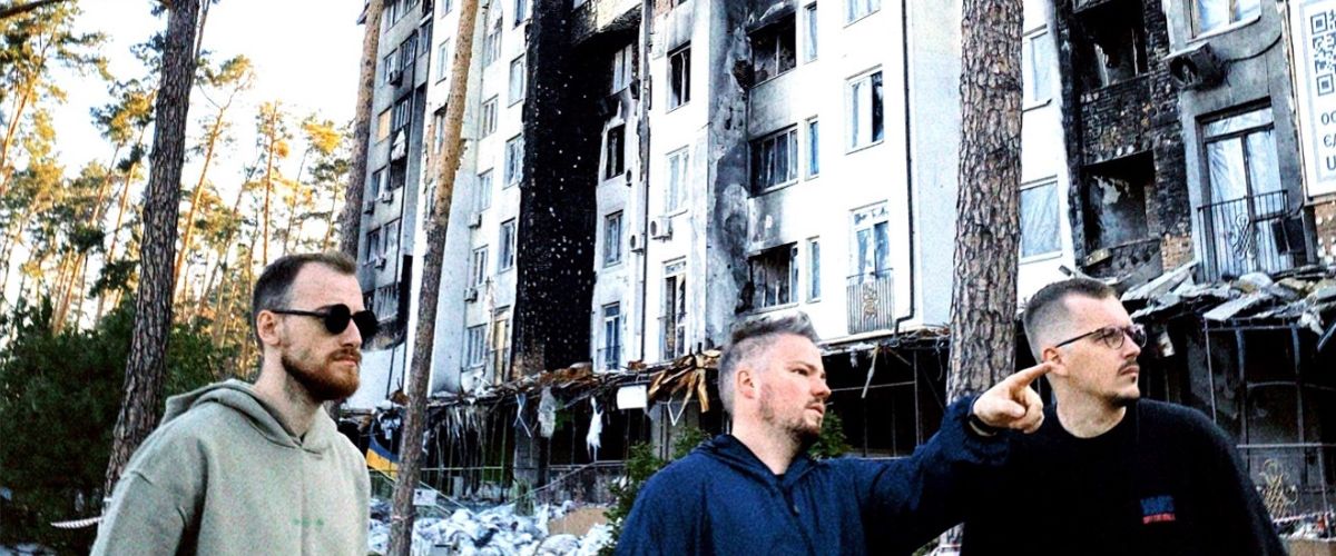 Personnel from TWR Ukraine set up a video shoot against a backdrop of buildings that have been heavily damaged in the war. Photo by TWR Ukraine
