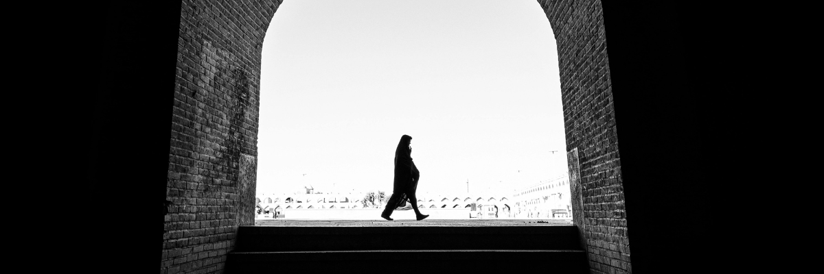 A woman walking in a street in Iran