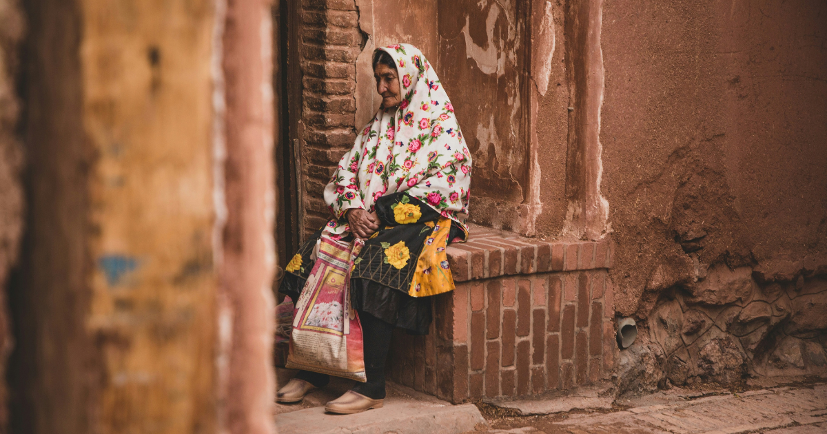 Iranian woman sitting in the street in Iran